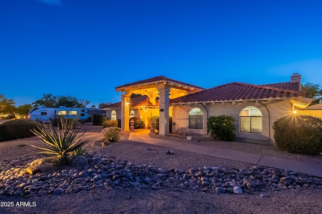13108 N 76th St, Scottsdale, AZ 85260 - mediterranean / spanish house featuring a tiled roof, stucco siding, and a chimney