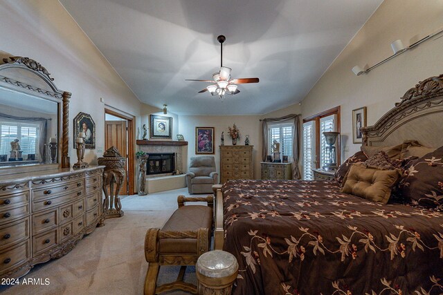 13108 N 76th St, Scottsdale, AZ 85260 - bedroom featuring light carpet, lofted ceiling, a fireplace with raised hearth, and a ceiling fan