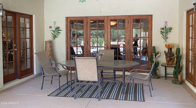 dining space featuring french doors and concrete flooring