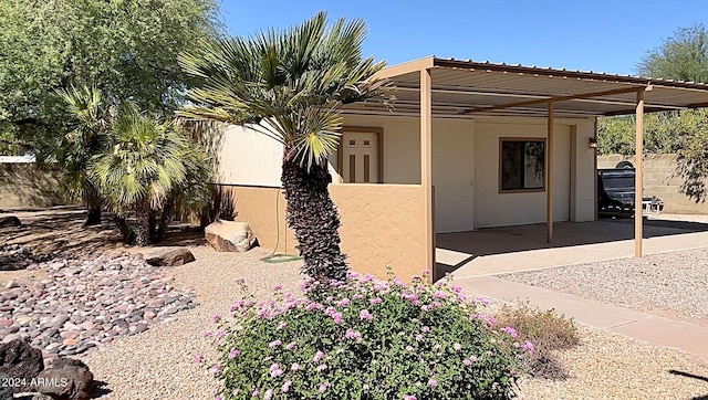 view of side of property featuring a carport