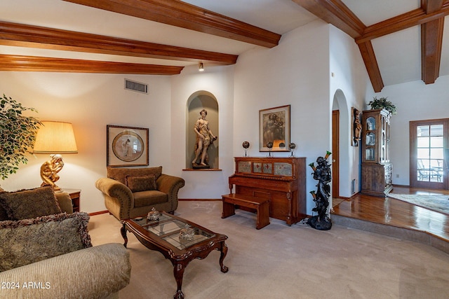 living room featuring vaulted ceiling with beams and light wood-type flooring