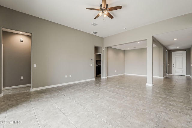 unfurnished living room featuring baseboards, a ceiling fan, visible vents, and light tile patterned floors