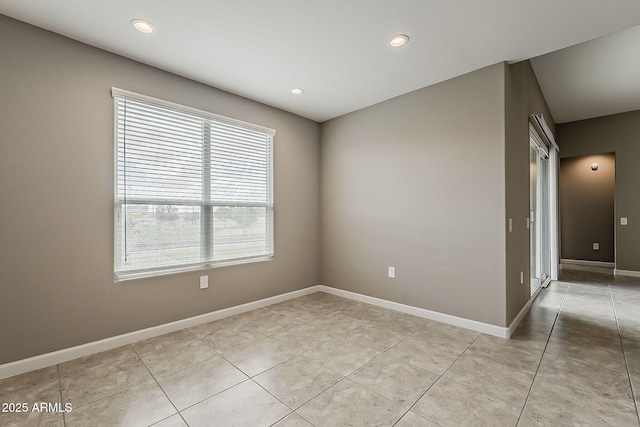 spare room featuring light tile patterned floors, baseboards, and recessed lighting