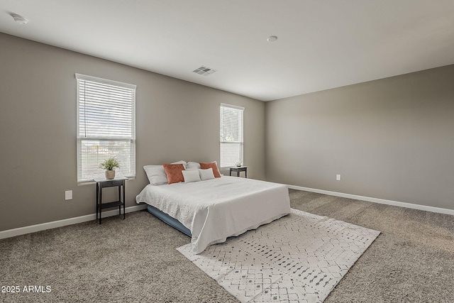 bedroom featuring baseboards, visible vents, and carpet