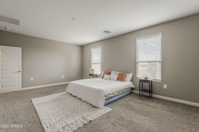 carpeted bedroom with baseboards and visible vents