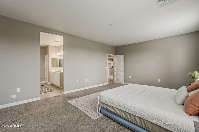 bedroom with baseboards, visible vents, carpet floors, and connected bathroom