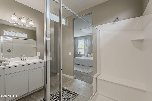 ensuite bathroom featuring tile patterned floors, ensuite bath, vanity, and a shower with door