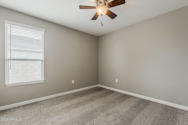 carpeted spare room with a ceiling fan, baseboards, and a healthy amount of sunlight