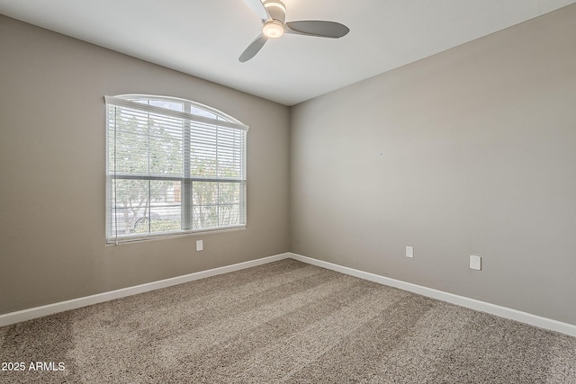 unfurnished room featuring carpet, baseboards, and ceiling fan