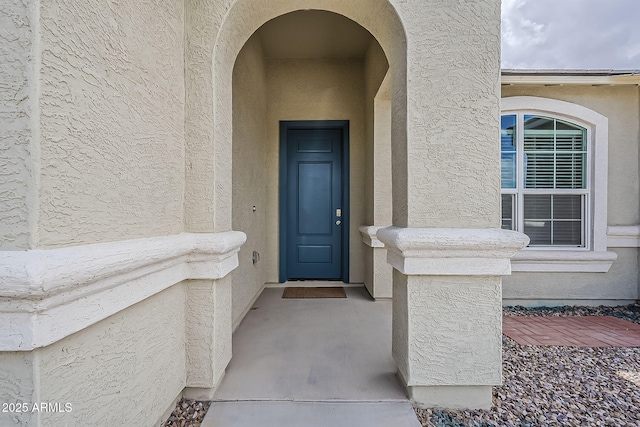doorway to property with stucco siding
