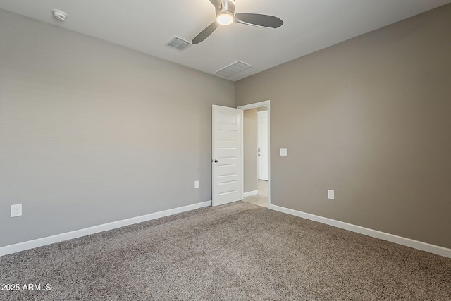 unfurnished room featuring baseboards, visible vents, a ceiling fan, and light colored carpet