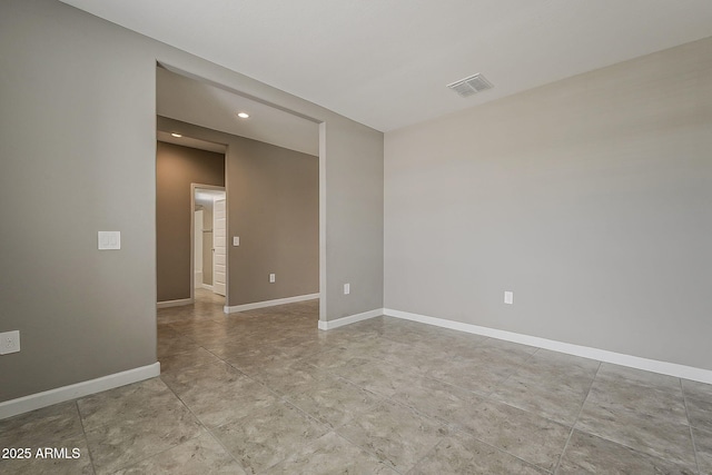 spare room with baseboards, visible vents, and recessed lighting