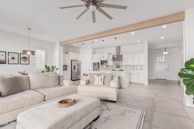 living room with ceiling fan and beamed ceiling