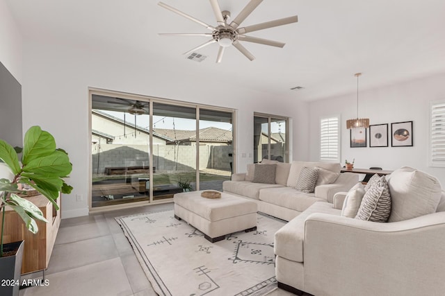 living room featuring ceiling fan and a healthy amount of sunlight