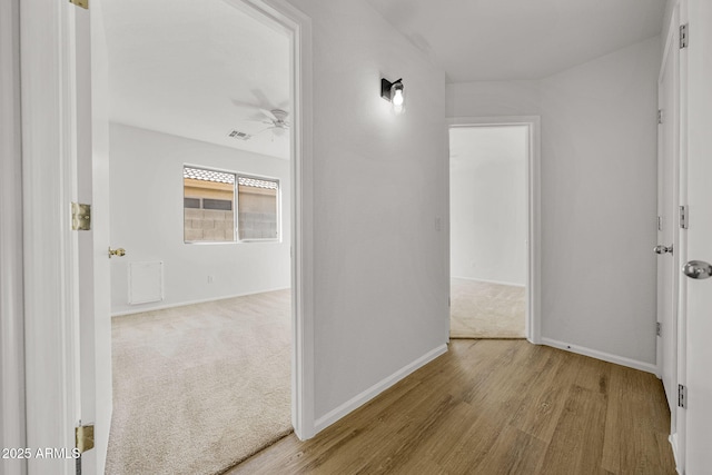 hallway with light colored carpet