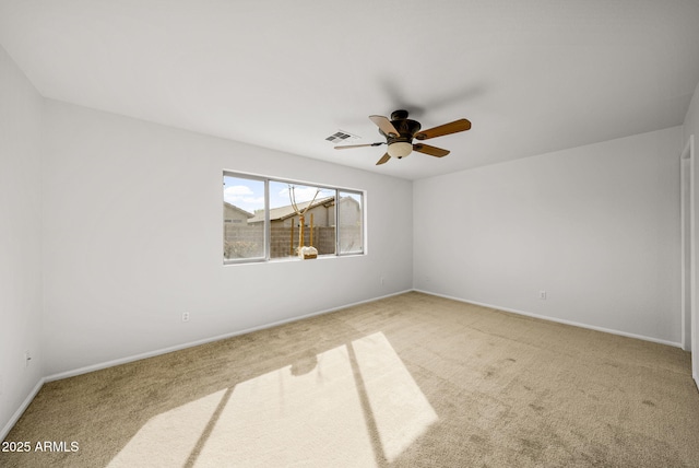 unfurnished room with light colored carpet and ceiling fan