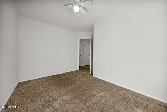 carpeted spare room featuring ceiling fan