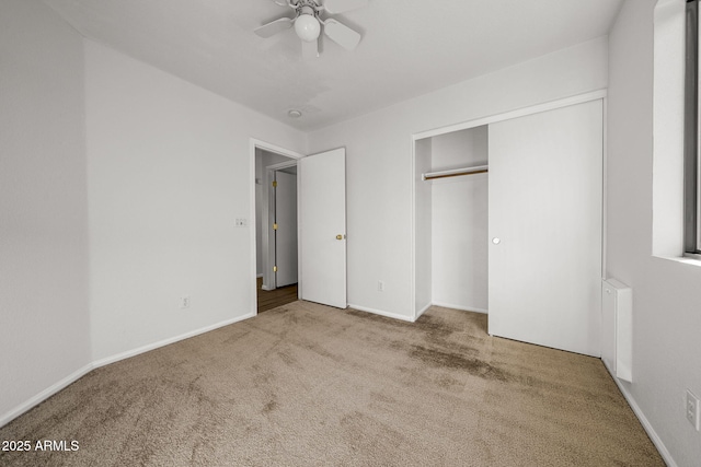 unfurnished bedroom with a closet, ceiling fan, and carpet