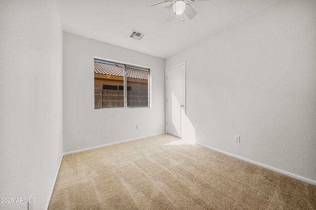 empty room featuring ceiling fan and light colored carpet