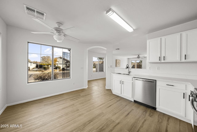 kitchen featuring sink, light hardwood / wood-style flooring, ceiling fan, stainless steel appliances, and white cabinets