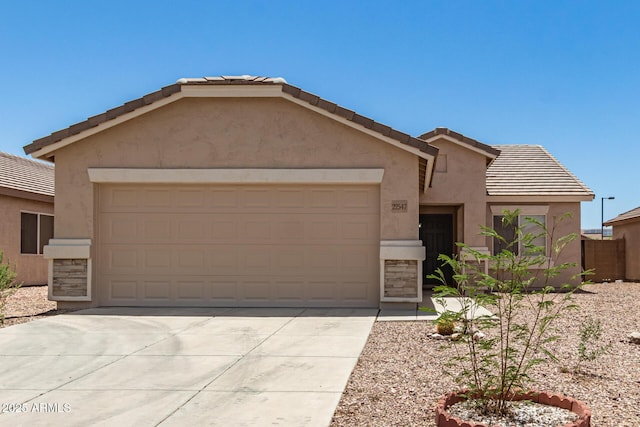22547 W Pima St, Buckeye, AZ 85326 - view of front of property with a garage, stucco siding, concrete driveway, and a tile roof