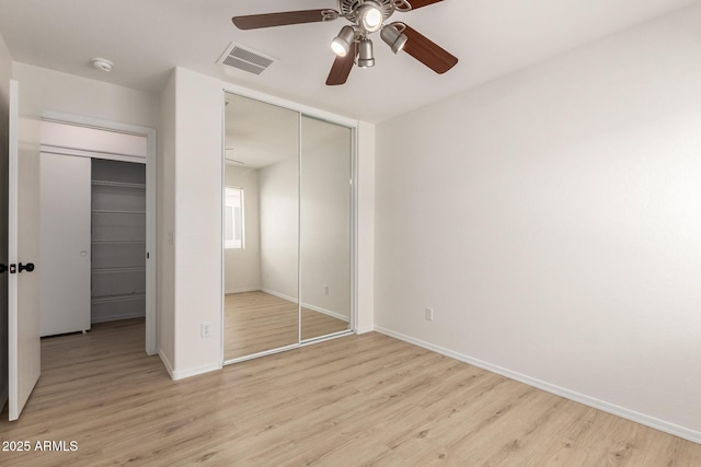 22547 W Pima St, Buckeye, AZ 85326 - unfurnished bedroom featuring light wood finished floors, a closet, and a ceiling fan