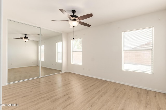 22547 W Pima St, Buckeye, AZ 85326 - unfurnished bedroom with a closet, light wood-style flooring, and ceiling fan