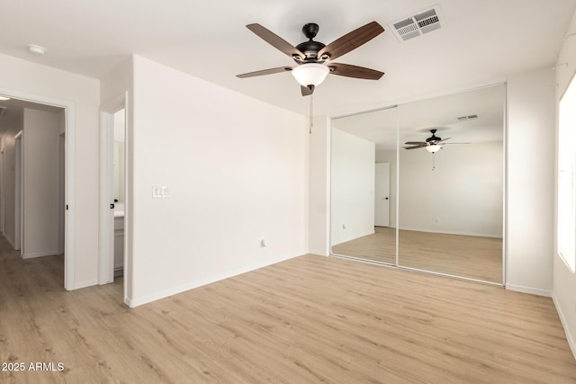 22547 W Pima St, Buckeye, AZ 85326 - unfurnished bedroom with light wood finished floors, a closet, and a ceiling fan