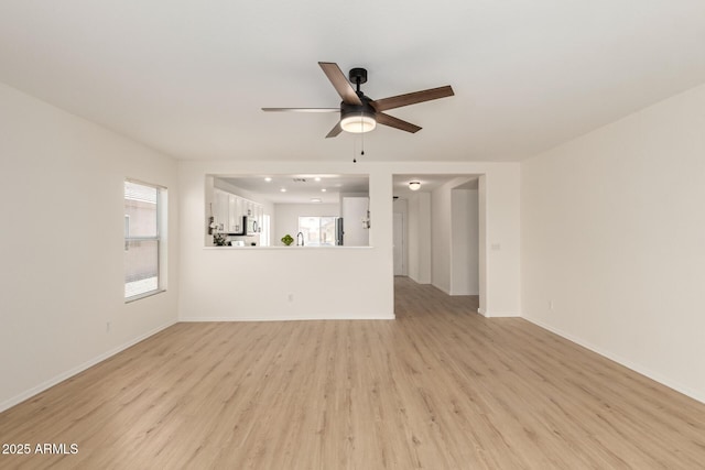 22547 W Pima St, Buckeye, AZ 85326 - unfurnished living room with ceiling fan and light wood-style floors