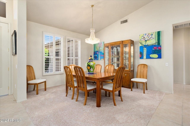 tiled dining room with vaulted ceiling