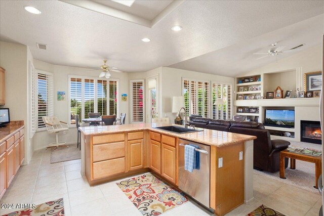 kitchen featuring plenty of natural light, dishwasher, ceiling fan, and sink