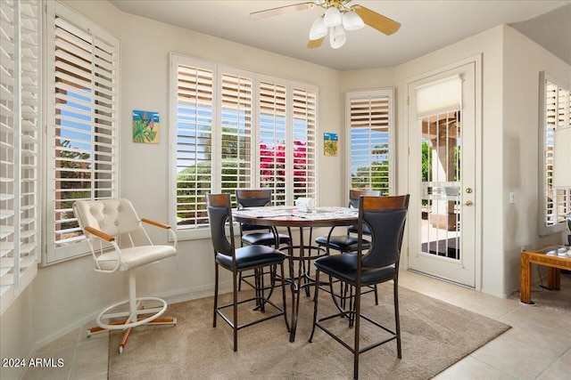 tiled dining area featuring ceiling fan