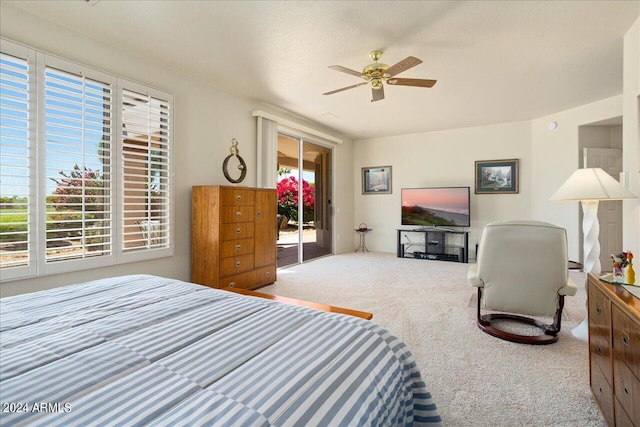 carpeted bedroom with multiple windows and ceiling fan