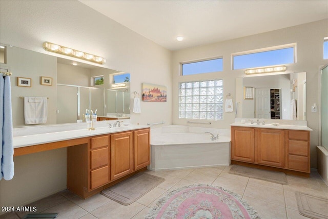 bathroom featuring tile floors, vanity, and a washtub