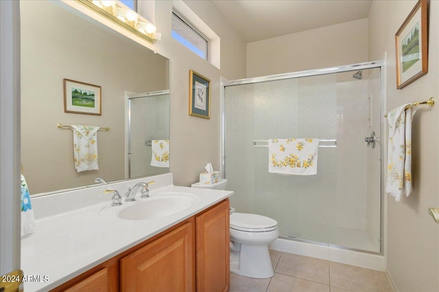 bathroom featuring a shower with shower door, toilet, tile flooring, and vanity