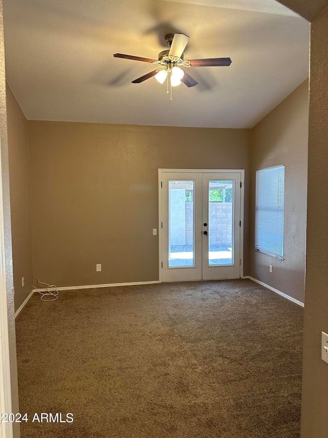 carpeted empty room with french doors and ceiling fan