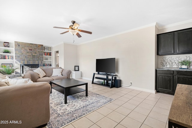 tiled living room featuring ceiling fan, a large fireplace, built in features, and ornamental molding