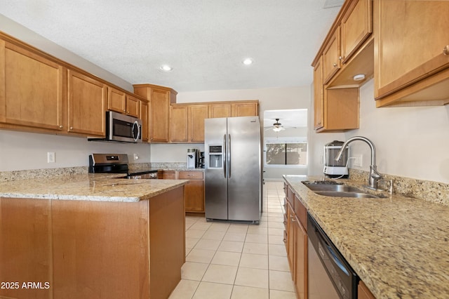 kitchen featuring sink, light tile patterned floors, light stone countertops, and stainless steel appliances