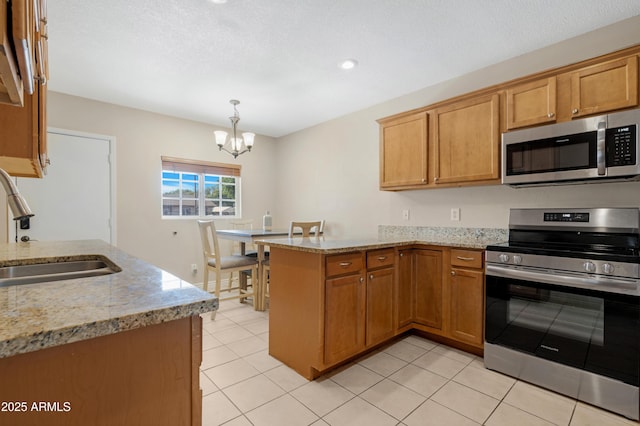 kitchen with pendant lighting, stainless steel appliances, sink, kitchen peninsula, and light stone counters