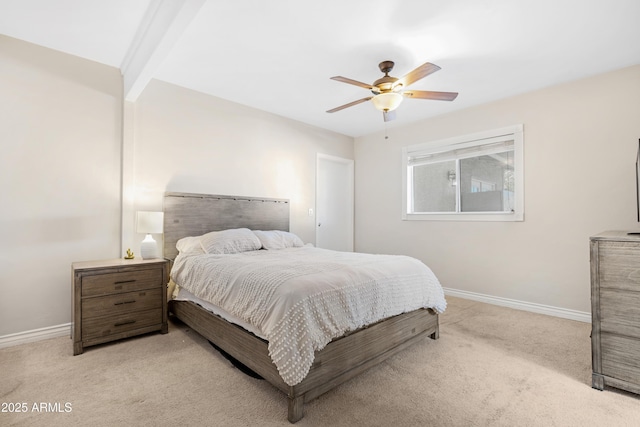 carpeted bedroom featuring ceiling fan and beamed ceiling