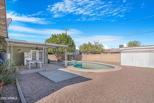 view of pool with ceiling fan and a patio area