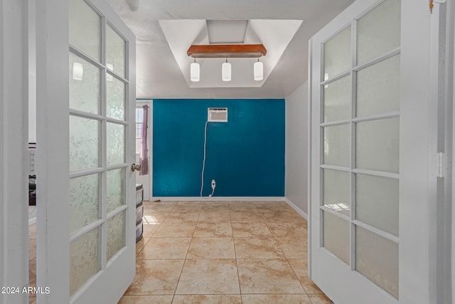 tiled foyer entrance with an AC wall unit