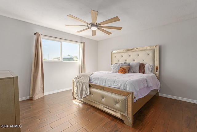 bedroom with dark wood-type flooring and ceiling fan