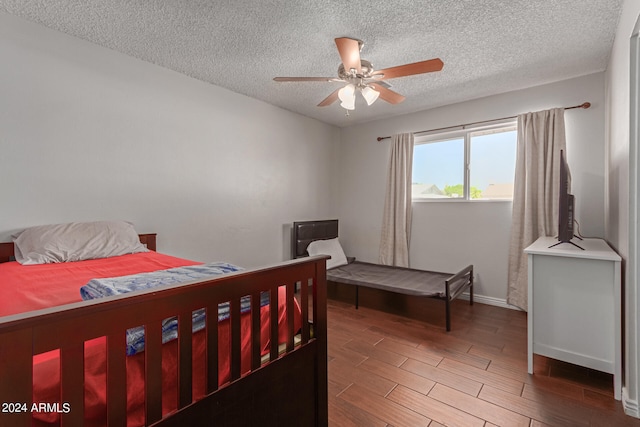 bedroom with a textured ceiling and ceiling fan