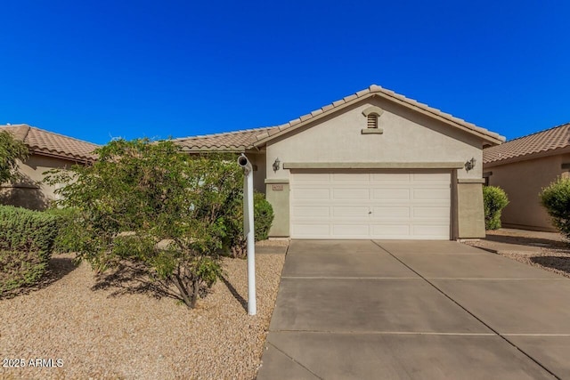 40713 N Courage Trl, Anthem, AZ 85086 - view of front of property featuring concrete driveway, stucco siding, an attached garage, and a tile roof