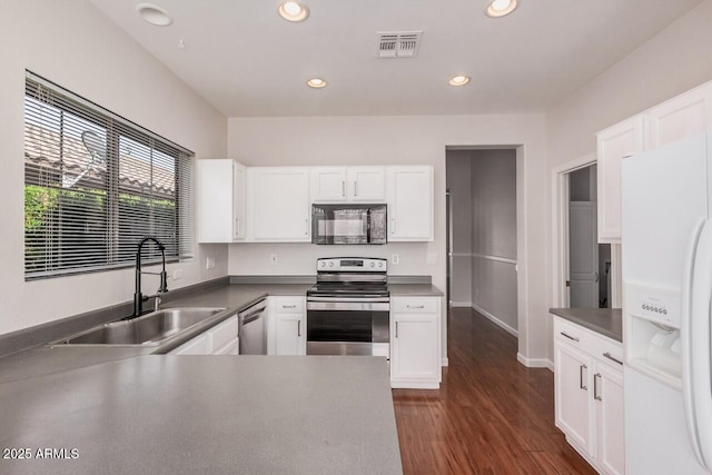 40713 N Courage Trl, Anthem, AZ 85086 - kitchen featuring appliances with stainless steel finishes, white cabinets, recessed lighting, and dark wood-style floors