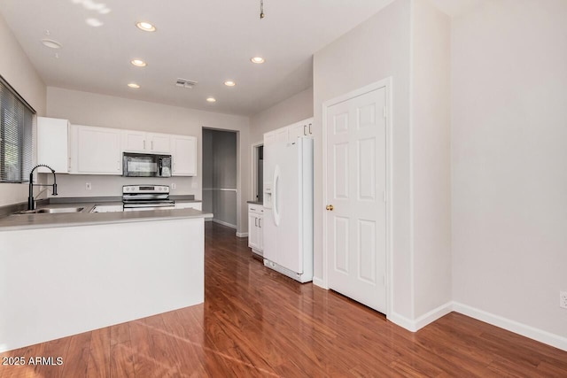 40713 N Courage Trl, Anthem, AZ 85086 - kitchen featuring black microwave, white refrigerator with ice dispenser, electric range, recessed lighting, and dark wood-style floors