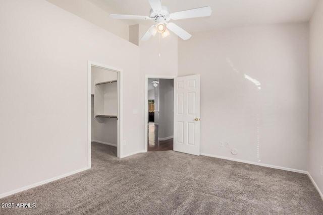 40713 N Courage Trl, Anthem, AZ 85086 - unfurnished bedroom featuring carpet, a spacious closet, a closet, high vaulted ceiling, and a ceiling fan