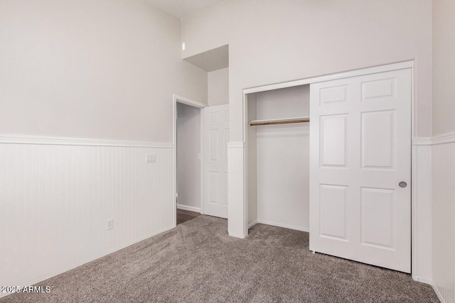 40713 N Courage Trl, Anthem, AZ 85086 - unfurnished bedroom featuring carpet, a wainscoted wall, and a closet