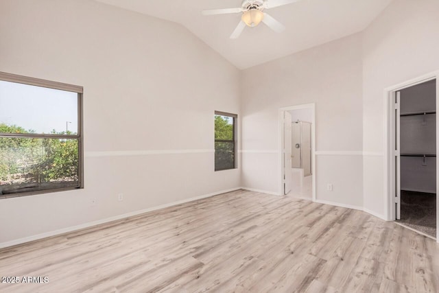 40713 N Courage Trl, Anthem, AZ 85086 - unfurnished bedroom featuring high vaulted ceiling, wood finished floors, a spacious closet, ensuite bath, and a ceiling fan